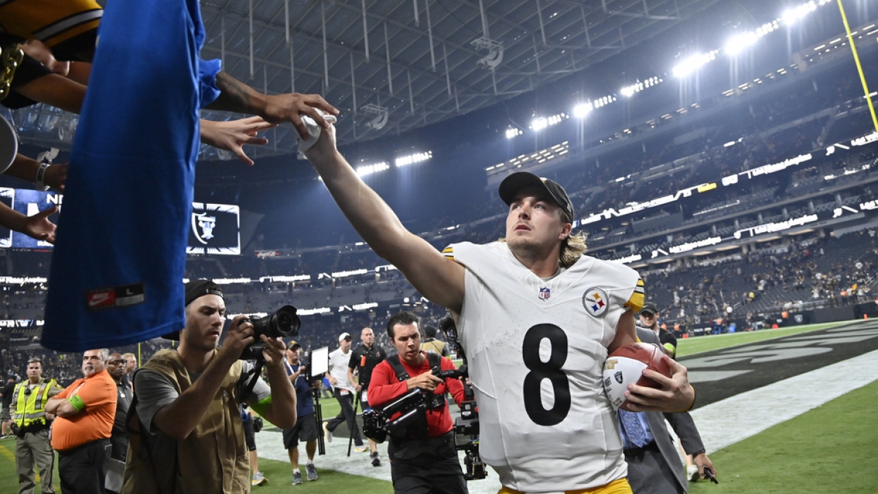 Pittsburgh Steelers quarterback Kenny Pickett gives his glove to a fan in the stands after a win over the Las Vegas Raiders