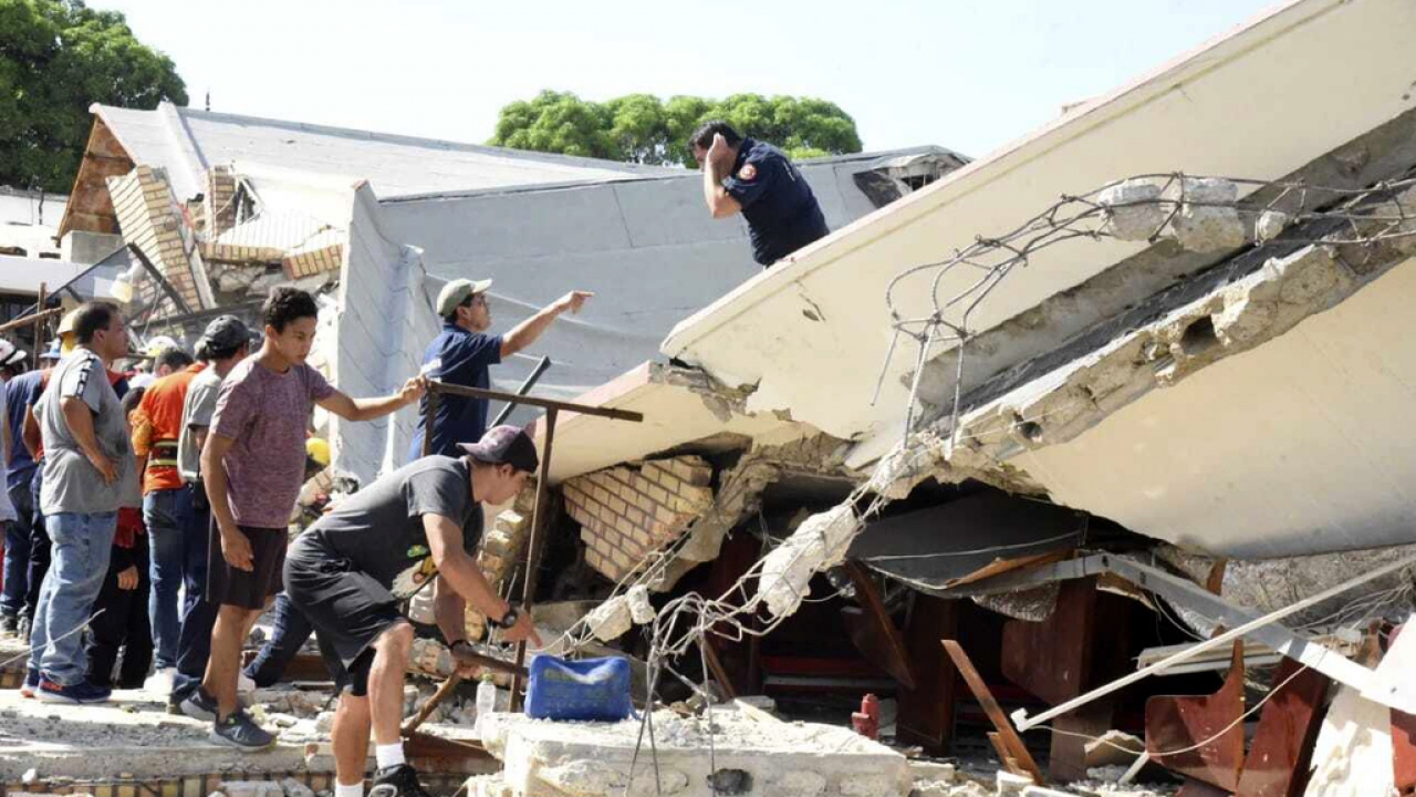 Rescue workers search for survivors amid debris after the roof of a church collapsed during a Sunday Mass in Mexico