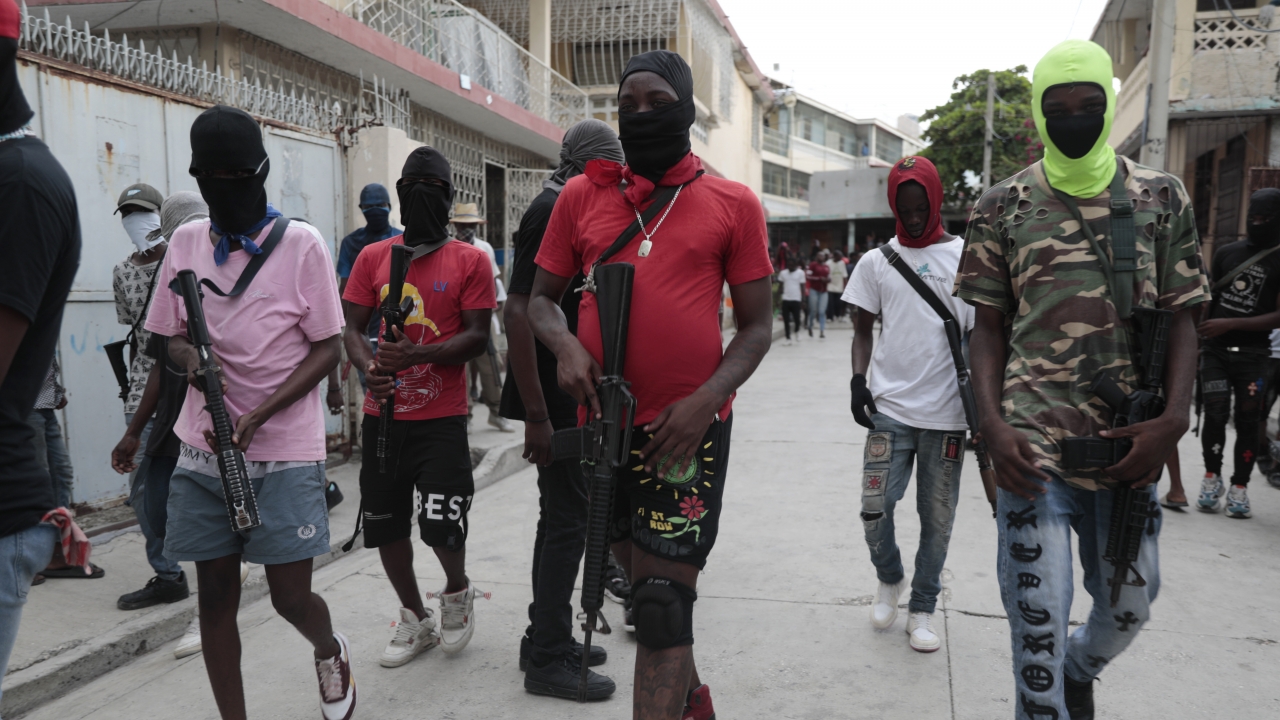 Armed members of "G9 and Family" march in a protest against Haitian Prime Minister Ariel Henry in Port-au-Prince.