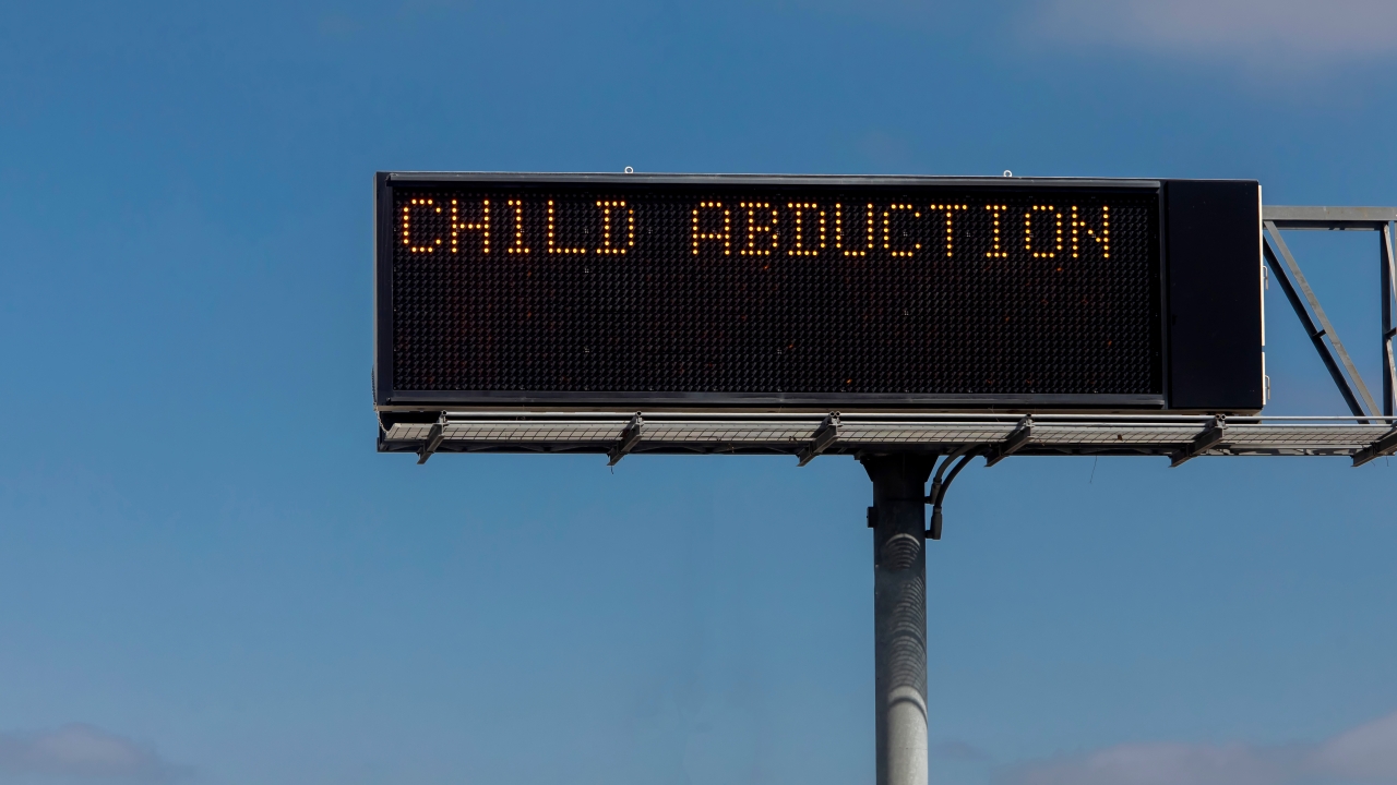 Roadway sign reads "Child Abduction"