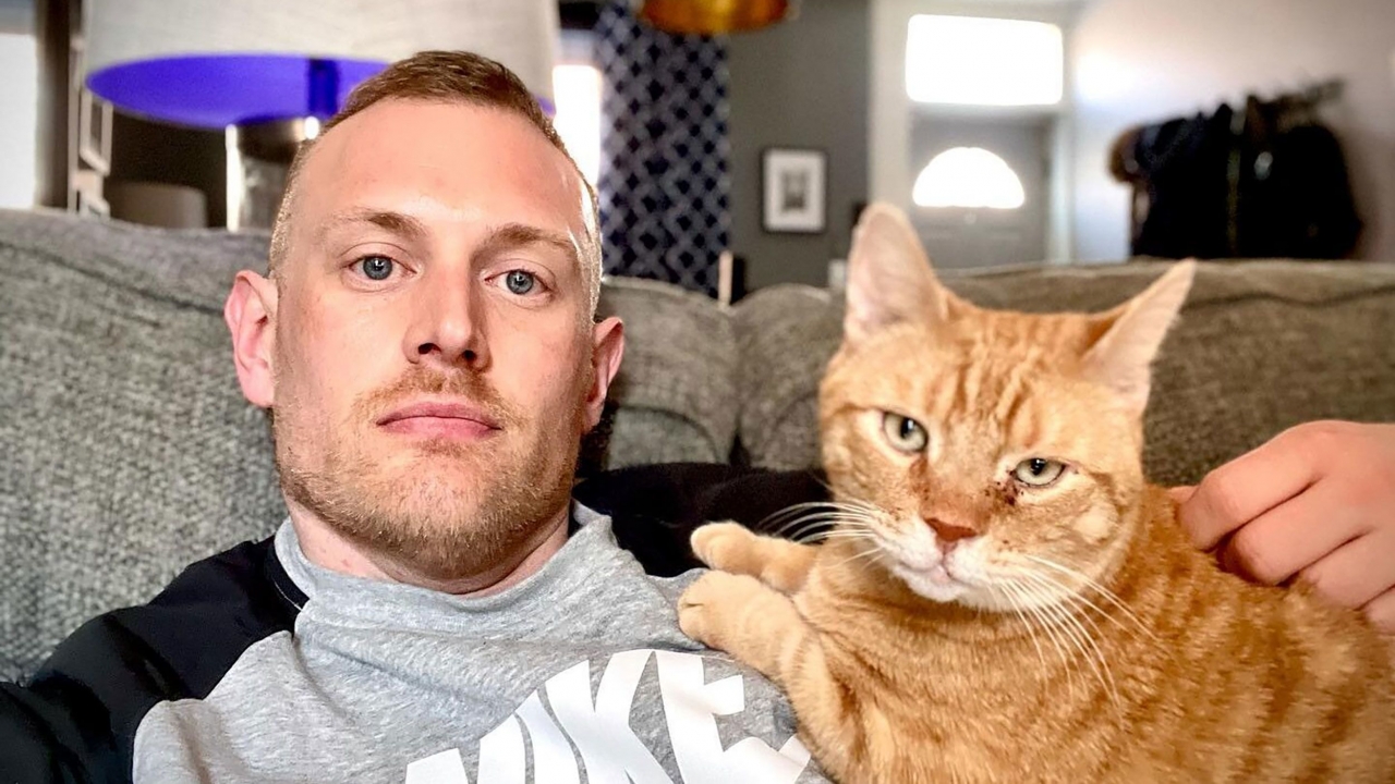 Josh Kruger poses with a cat