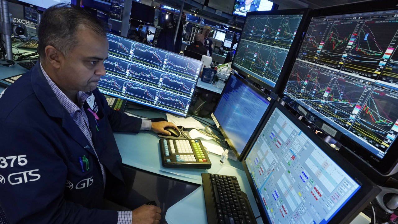 Specialist Dilip Patel works at his post on the floor of the New York Stock Exchange.