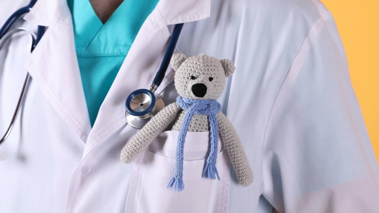 Pediatrician with a toy bear.