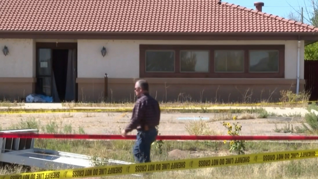 Exterior of Return to Nature Funeral Home surrounded by crime scene tape.