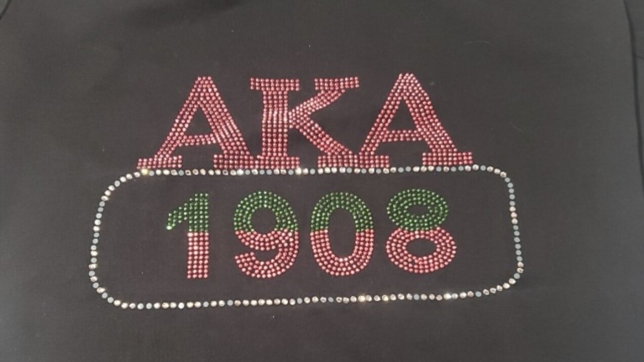 AKA sorority letters with the year 1908 in gemstones on a shitt