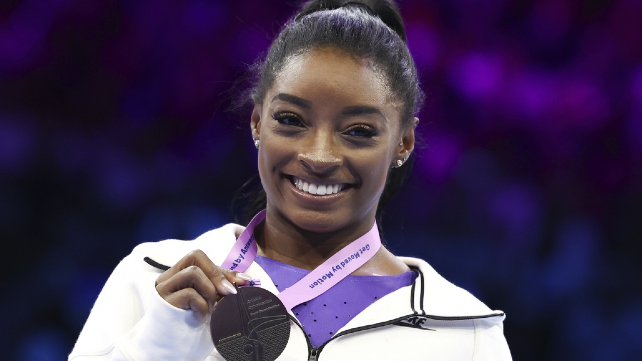 United States' Simone Biles shows her gold medal