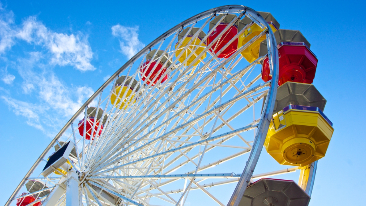 Underside view of a Ferris wheel rotating downward on California's Santa Monica Pier.