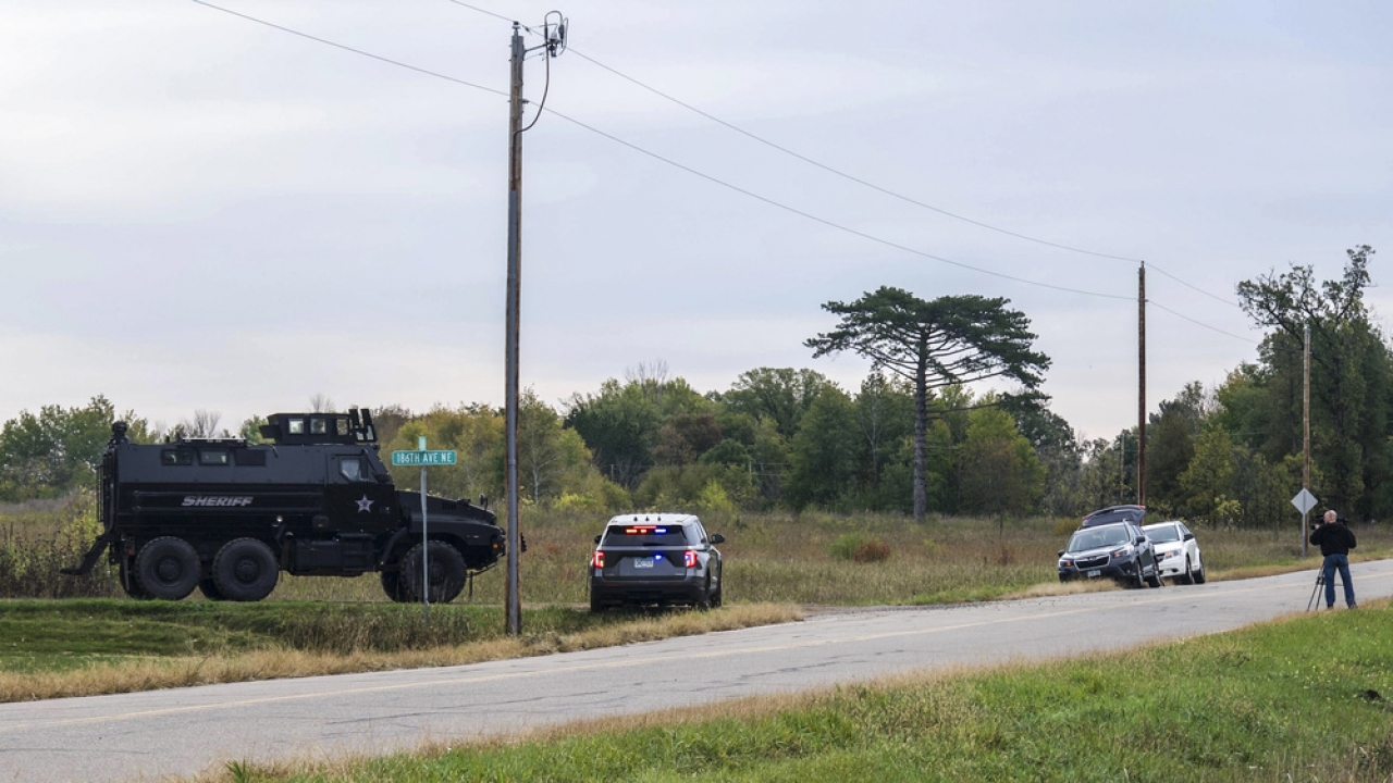 An armored vehicle and police at the edge of a field in in Glendorado Township, Minnesota.