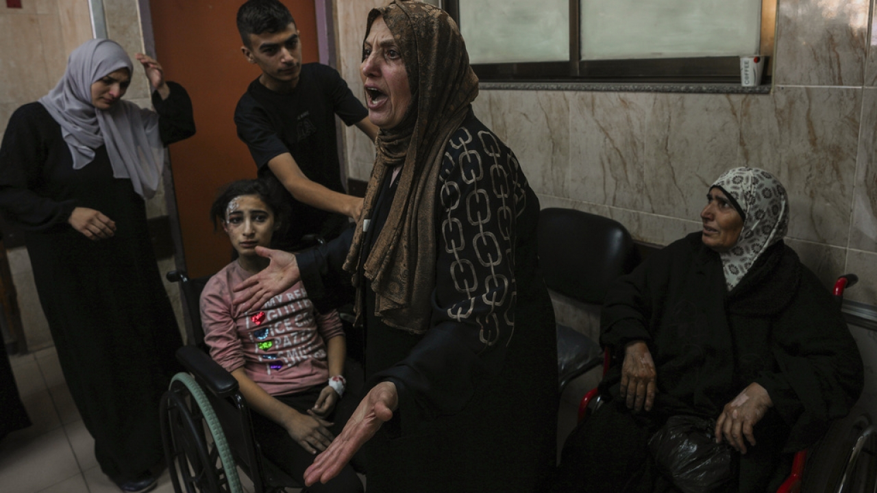 A Palestinian woman reacts next to the wounded during an Israeli airstrike