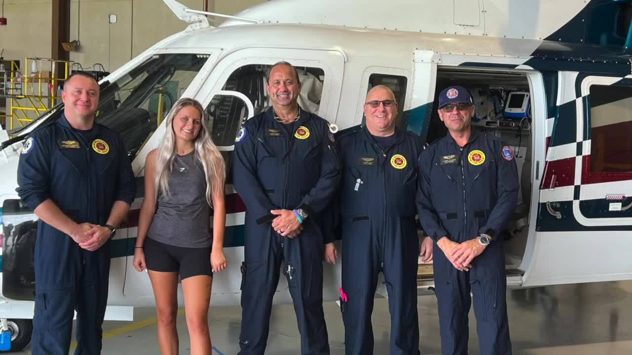 Layla Rogan poses with firefighters