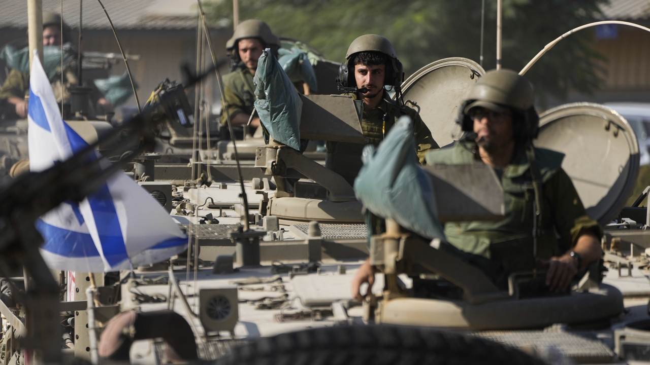 Israeli soldiers gather in a staging area near the border with Gaza Strip.