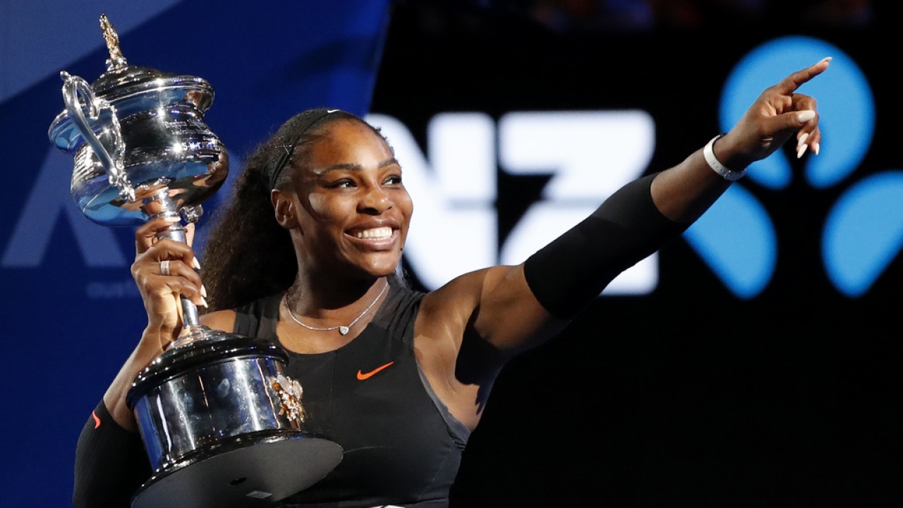 Serena Williams holds a trophy.