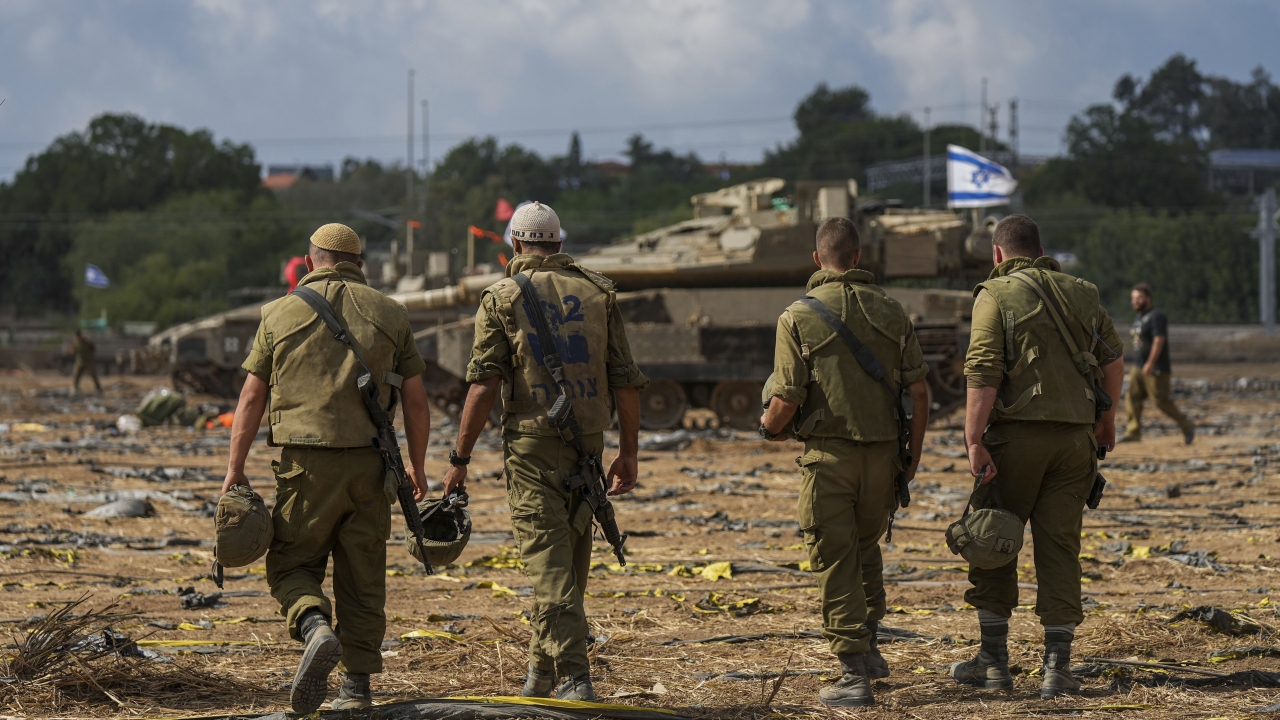 Israeli soldiers gather in a staging area near the border with Gaza Strip, in southern Israel.