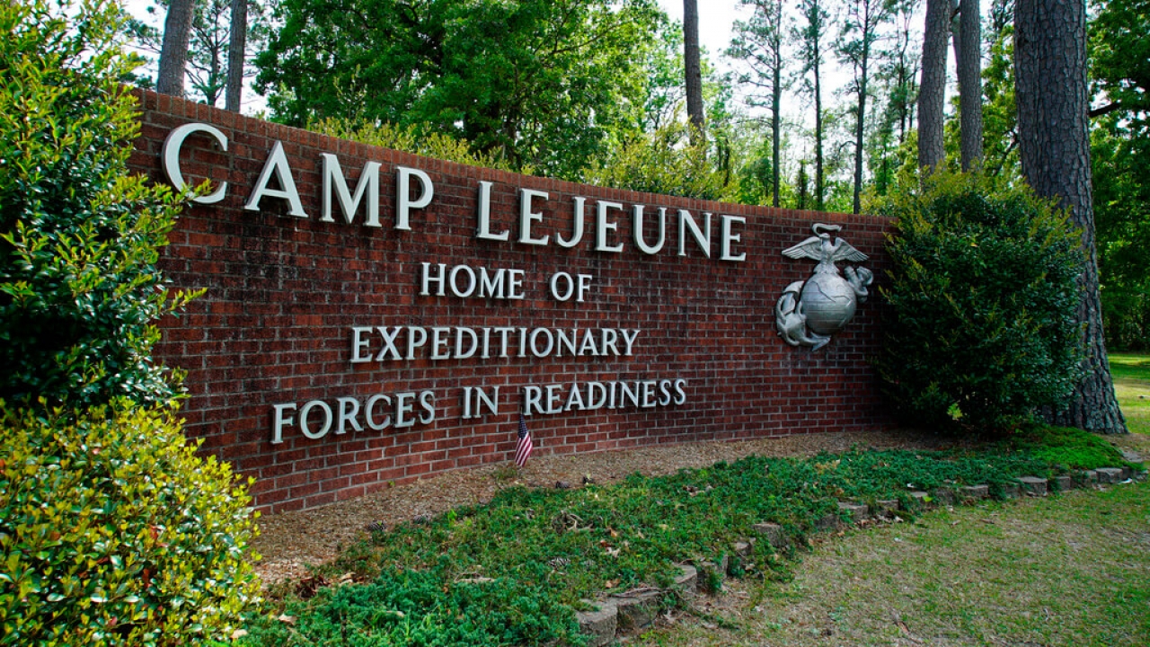 Signage stands on the main gate to Camp Lejeune Marine Base.