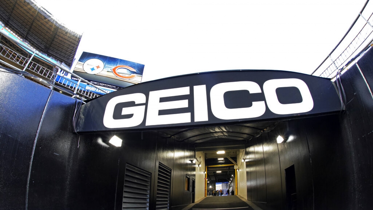 GEICO sign in the tunnel leading to the visitors locker room before an NFL football game.