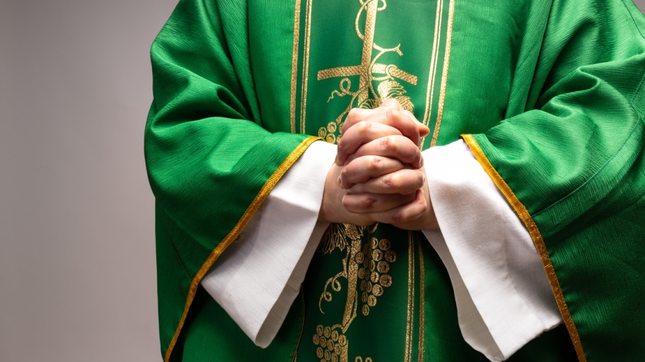 Priest with hands folded