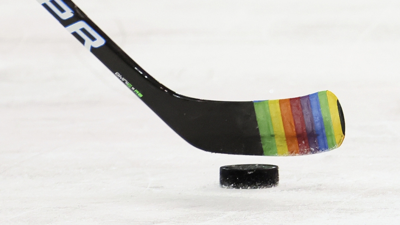 Hockey stick decorated with "Pride Night" tape.