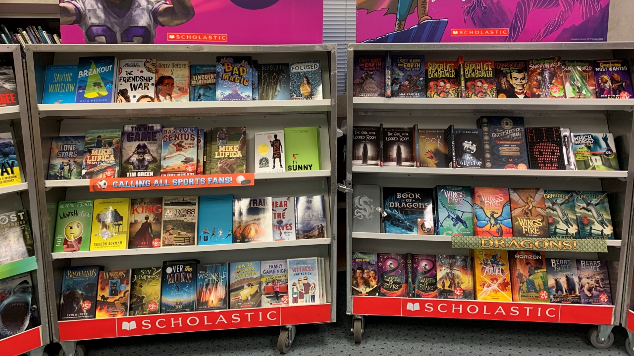 A Scholastic book fair display is shown.