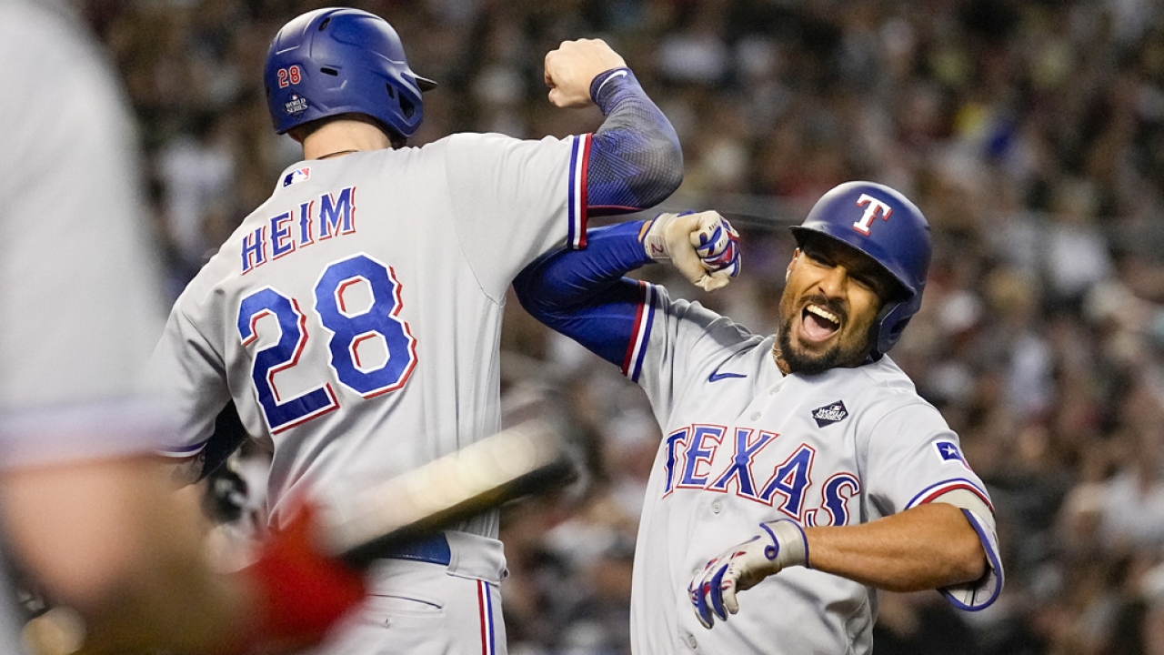 Texas Rangers' Marcus Semien, right, celebrates his three-run home run with Jonah Heim.