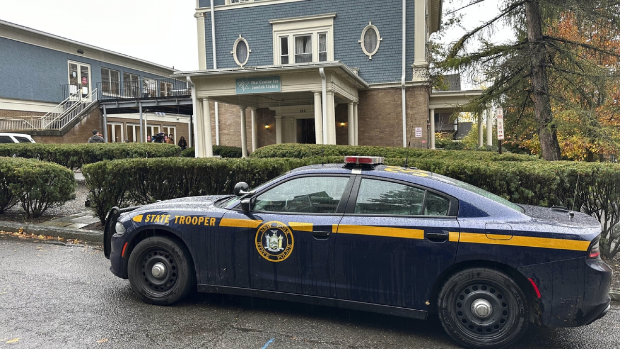 A New York State Police Department cruiser is parked in front of Cornell University's Center for Jewish Living