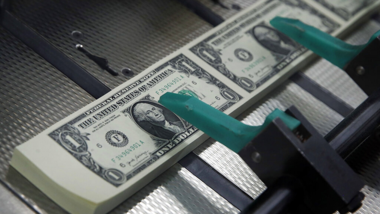 $1 bills with the signatures of U.S. Treasurer Jovita Carranza and Treasury Secretary Steven Mnuchin are cut