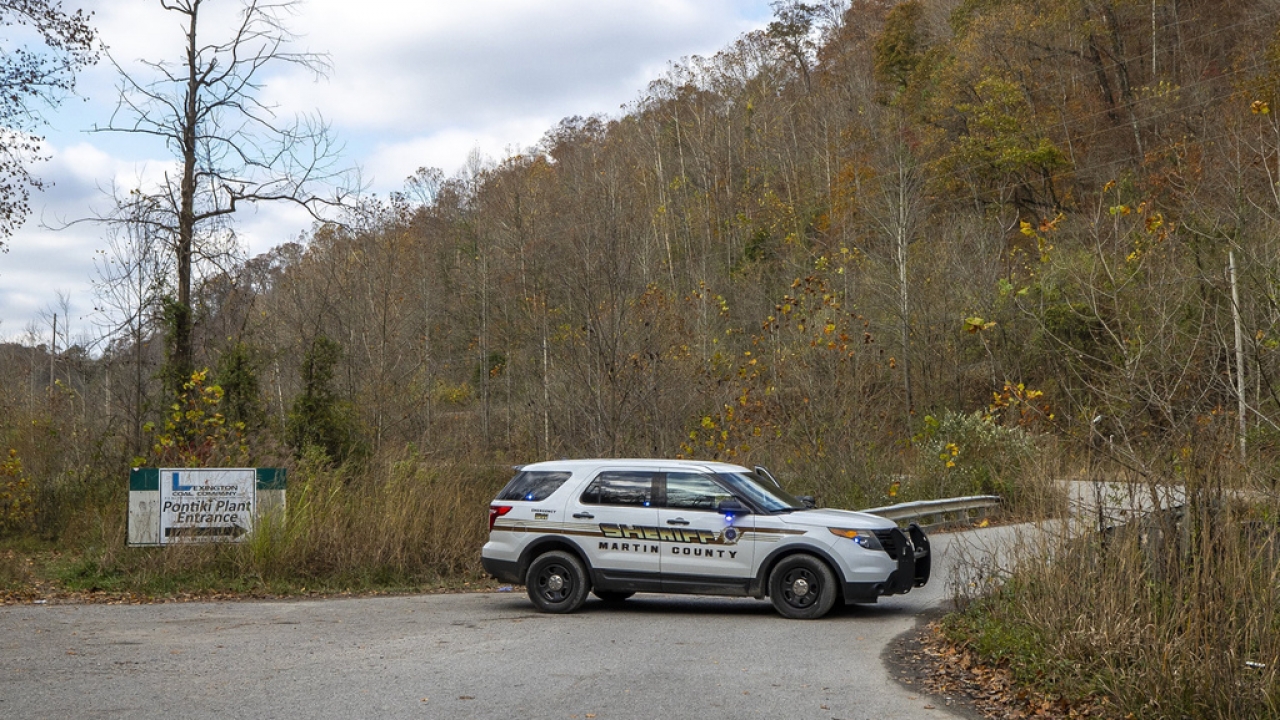 A sheriff's vehicle blocks a road leading to the area of a collapsed coal preparation plant.