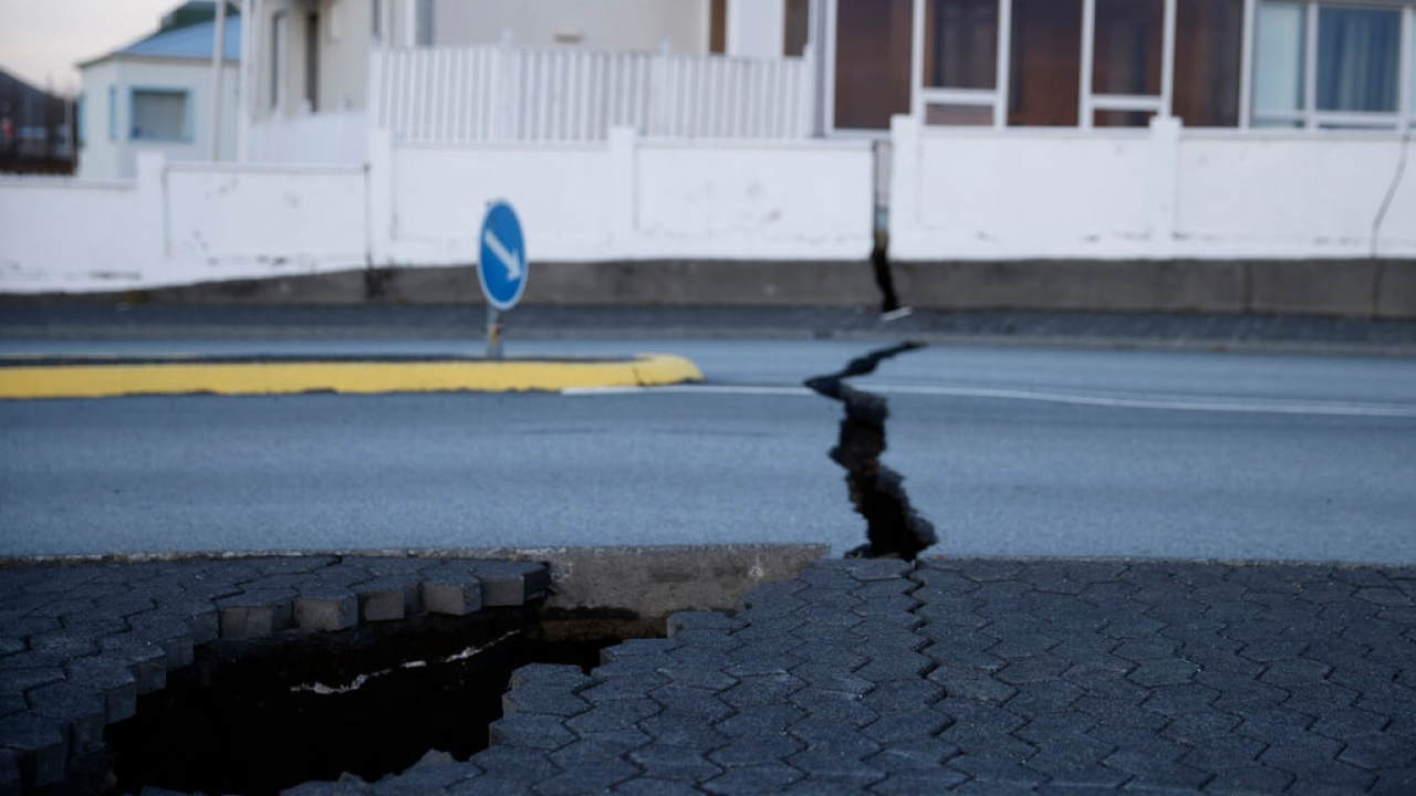 A fissure stretches across a road in Grindavik, Iceland, following an earthquake