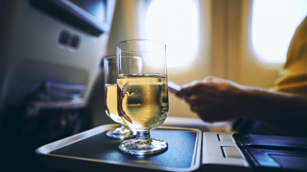 Stock image of two glasses of wine on an airplane.