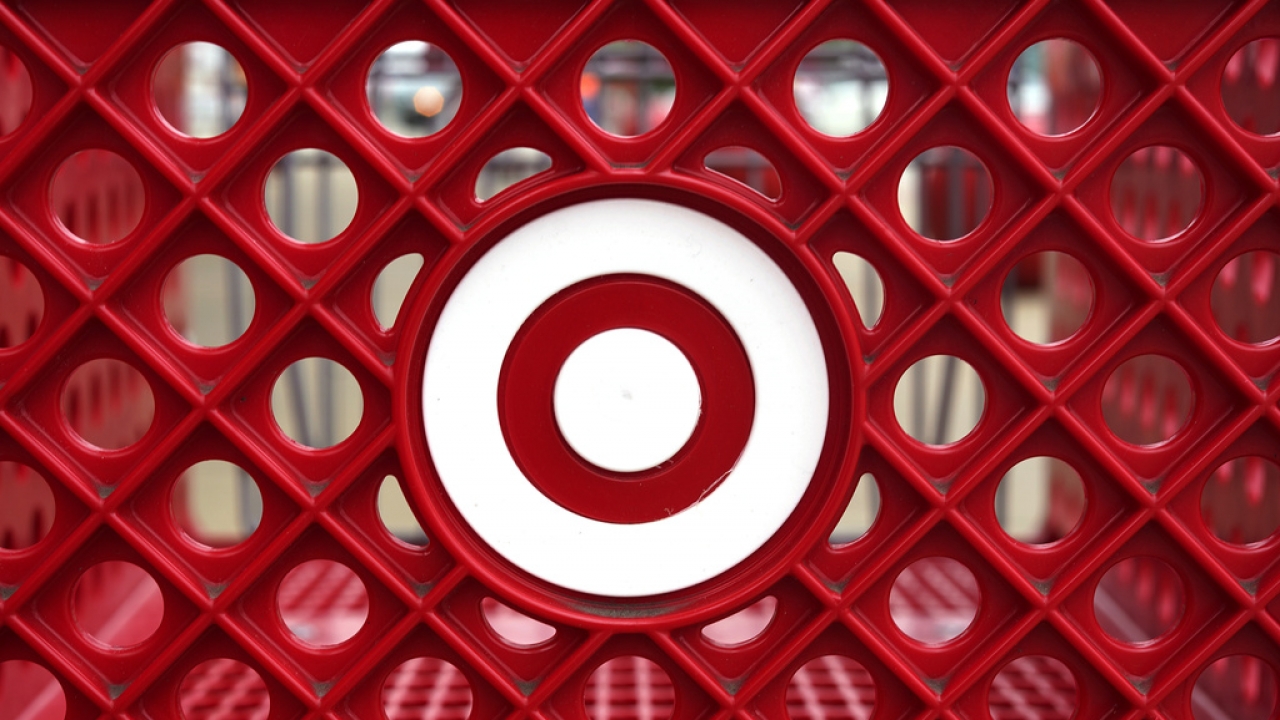 Target logo on the side of a shopping cart in a Target store .