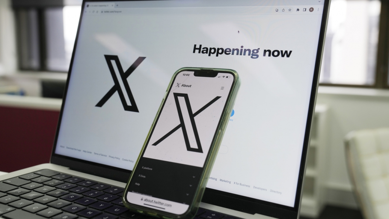 The opening page of X is displayed on a computer and phone.
