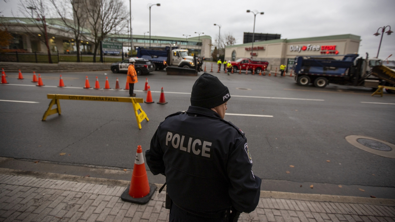 Police stand guard at the entrance to the Rainbow Bridge border crossing between the U.S. and Canada.