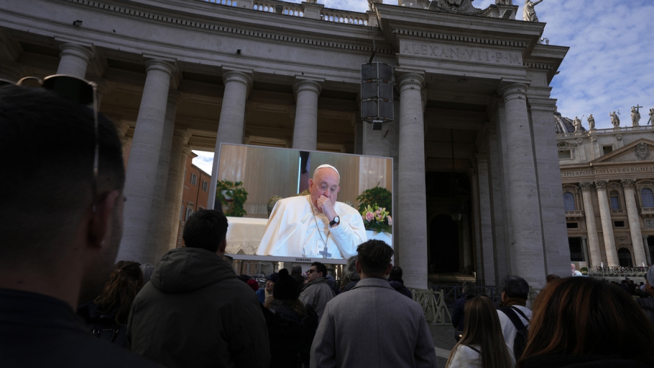A giant screen broadcasts Pope Francis during the Angelus noon prayer