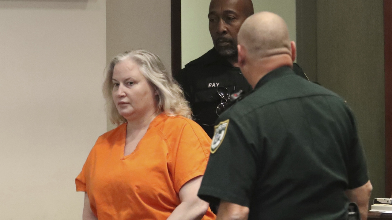 WWE Hall of Famer Tammy Sytch is escorted to the defense table by Volusia Couty Sheriff's bailiffs.