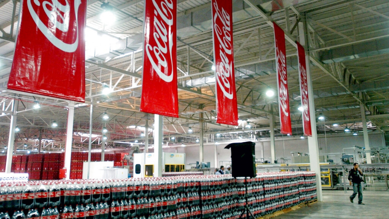 The Coca-Cola banners are seen hanging during the opening ceremony of a Coca-Cola plant.