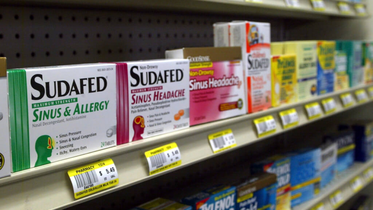 Sudafed and other common nasal decongestants displayed at a pharmacy.