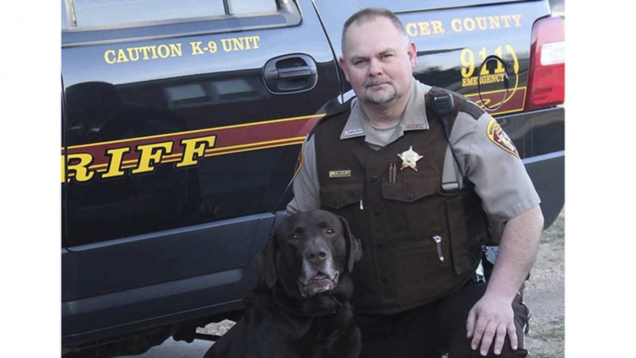 Sheriff's Deputy Paul Martin with his retired K9 Goliath.