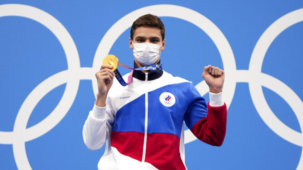 Evgeny Rylov of the Russian Olympic Committee poses with his gold medal after winning the men's 100-meter backstroke final.