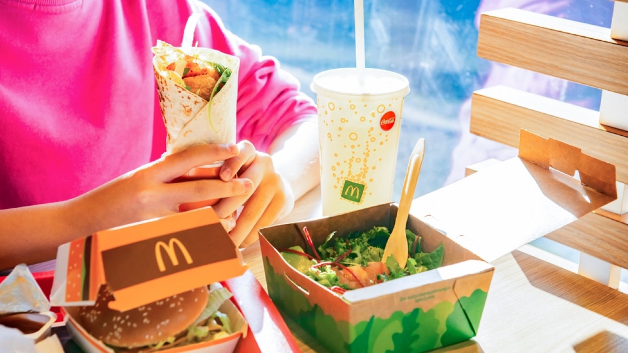 Woman eating a McDonald's meal with a chicken wrap in Poland