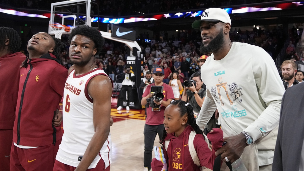 Southern California guard Bronny James (6) stands on the court next to his father LeBron James.