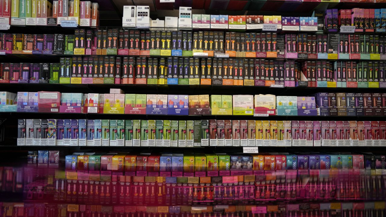 Disposable flavored electronic cigarette devices are displayed for sale.