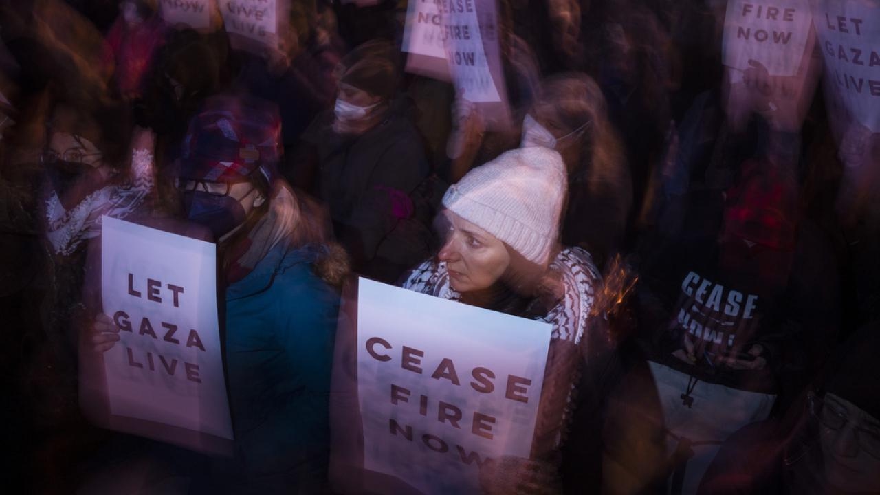 Demonstrators hold "ceasefire" signs during a Pro-Palestinian rally