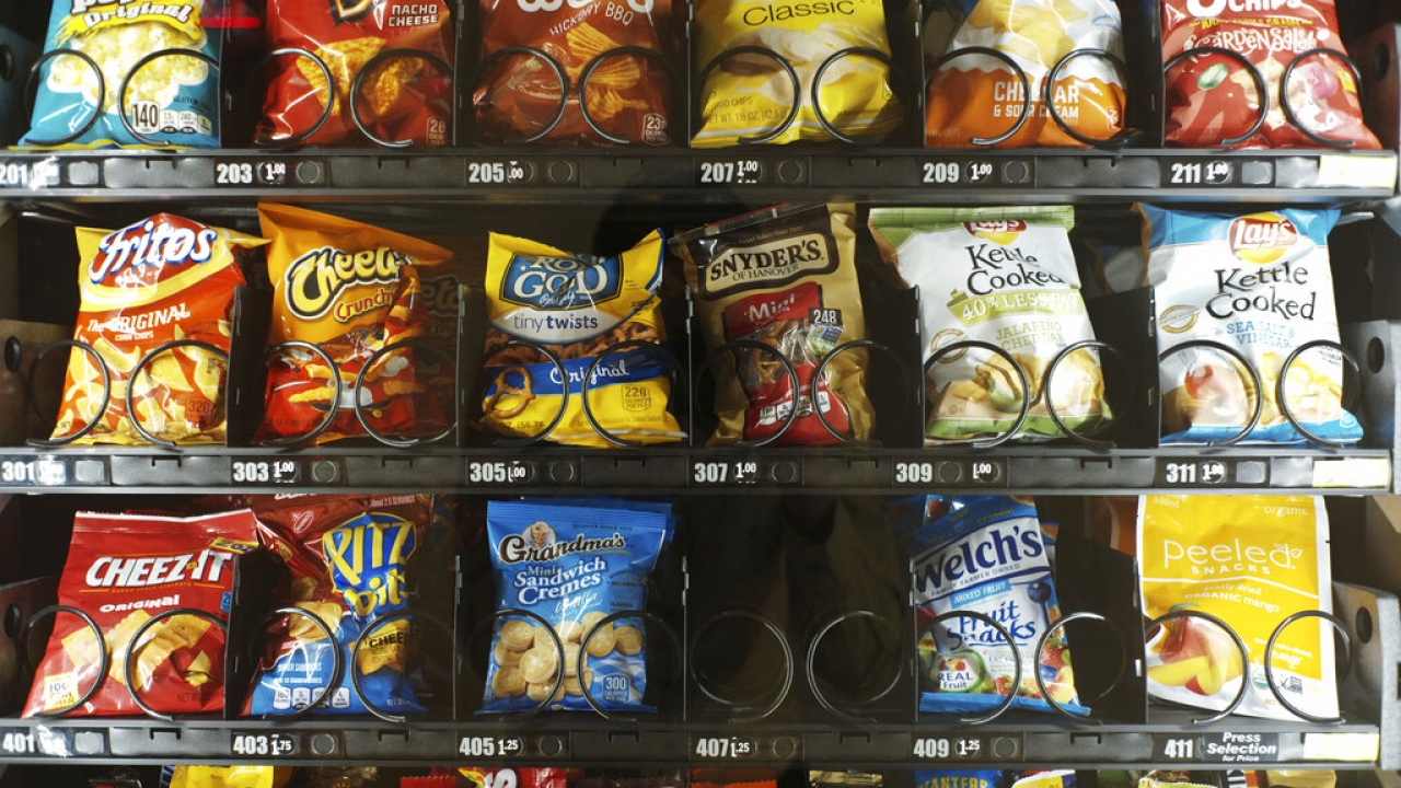Vending machine full of snacks, including chips and pretzels.
