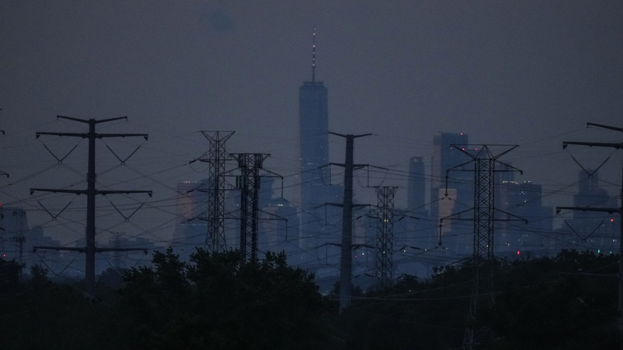 View of the New York City skyline. Electric transmission lines in NJ.