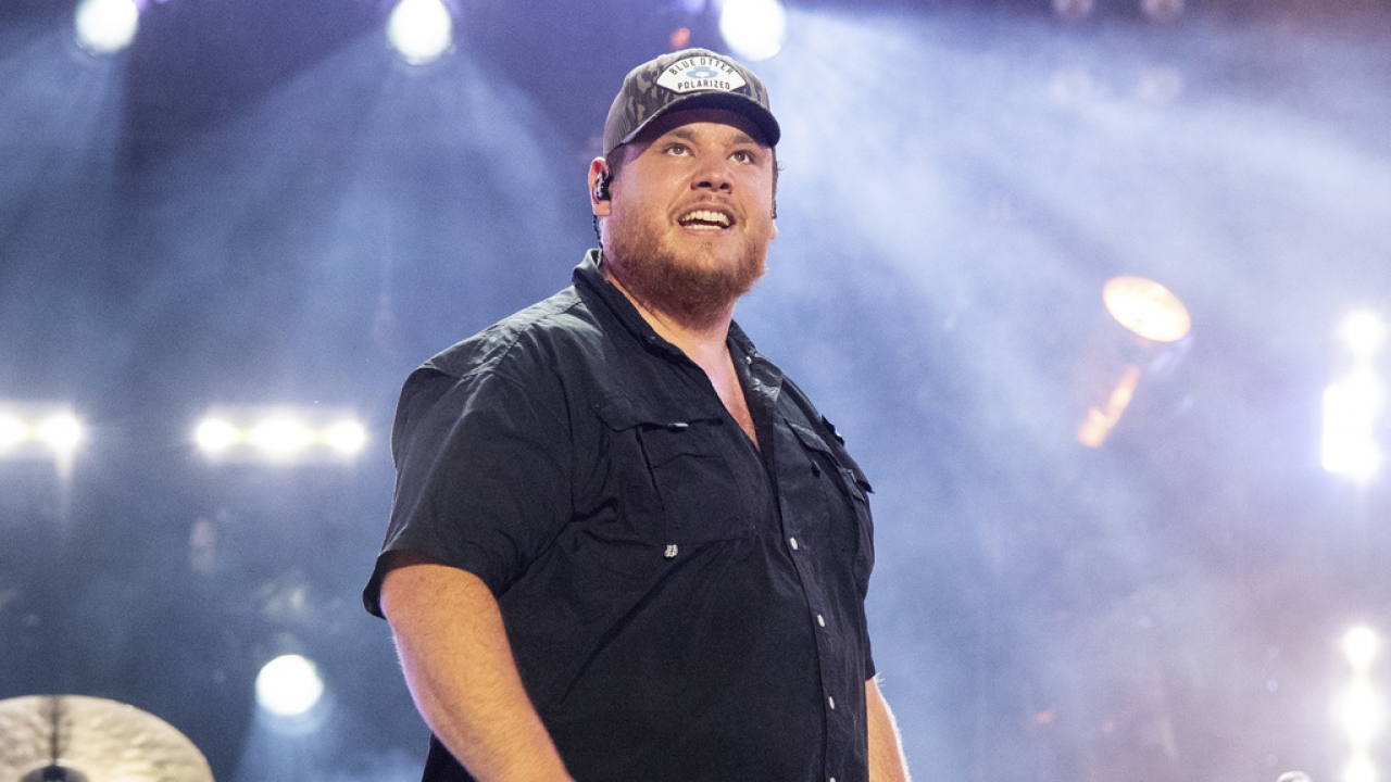 Luke Combs stands on stage.
