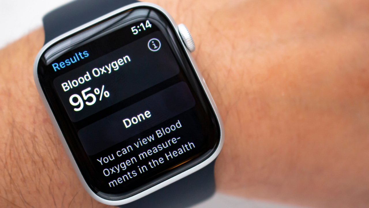 A person measuring blood oxygen levels on an Apple Watch Series 6, Blood Oxygen app.
