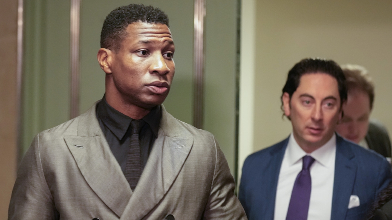 Jonathan Majors, left, enters a courtroom at the Manhattan criminal courts in New York.