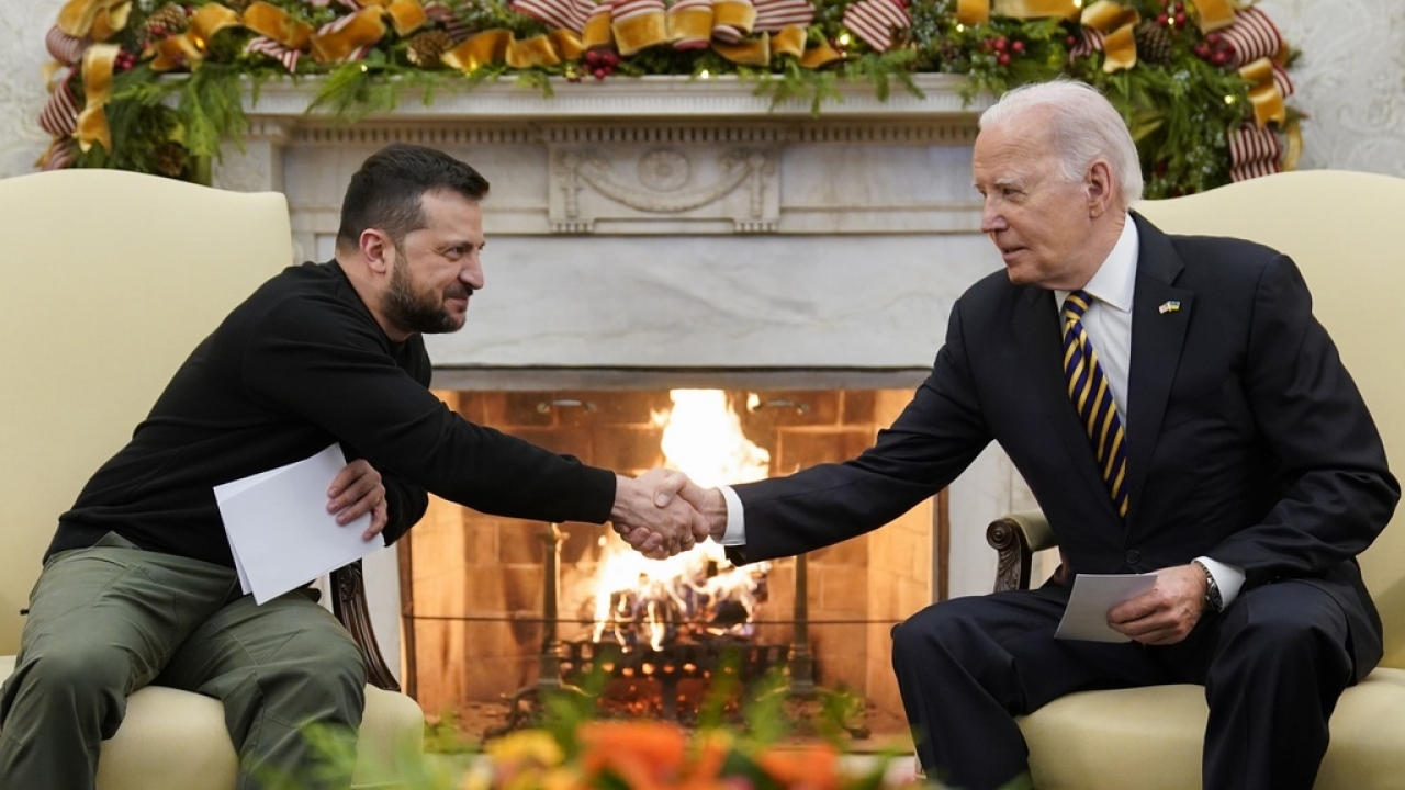 U.S. President Joe Biden shakes hands with Ukrainian President Volodymyr Zelenskyy.