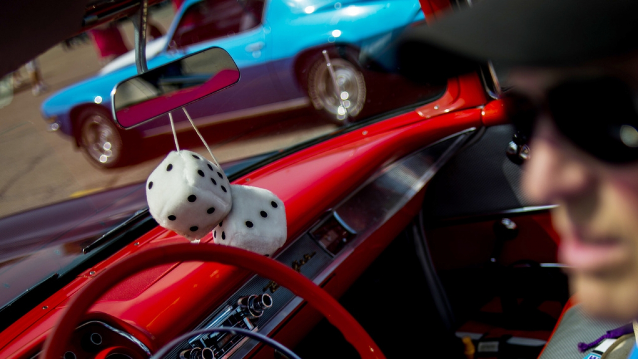 Fuzzy dice sit behind the rear-view mirror of a 1957 Chevrolet Bel Air, Aug. 4, 2014.