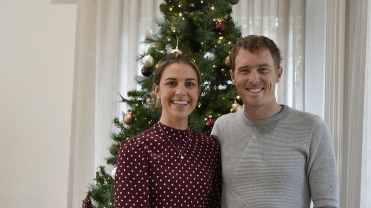 Melissa Hoskins and her husband Rohan Dennis standing in front of a Christmas tree.