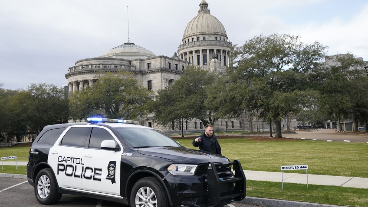 A Capitol Police officer warns off passersby as they respond to a bomb threat at the Mississippi State Capitol.